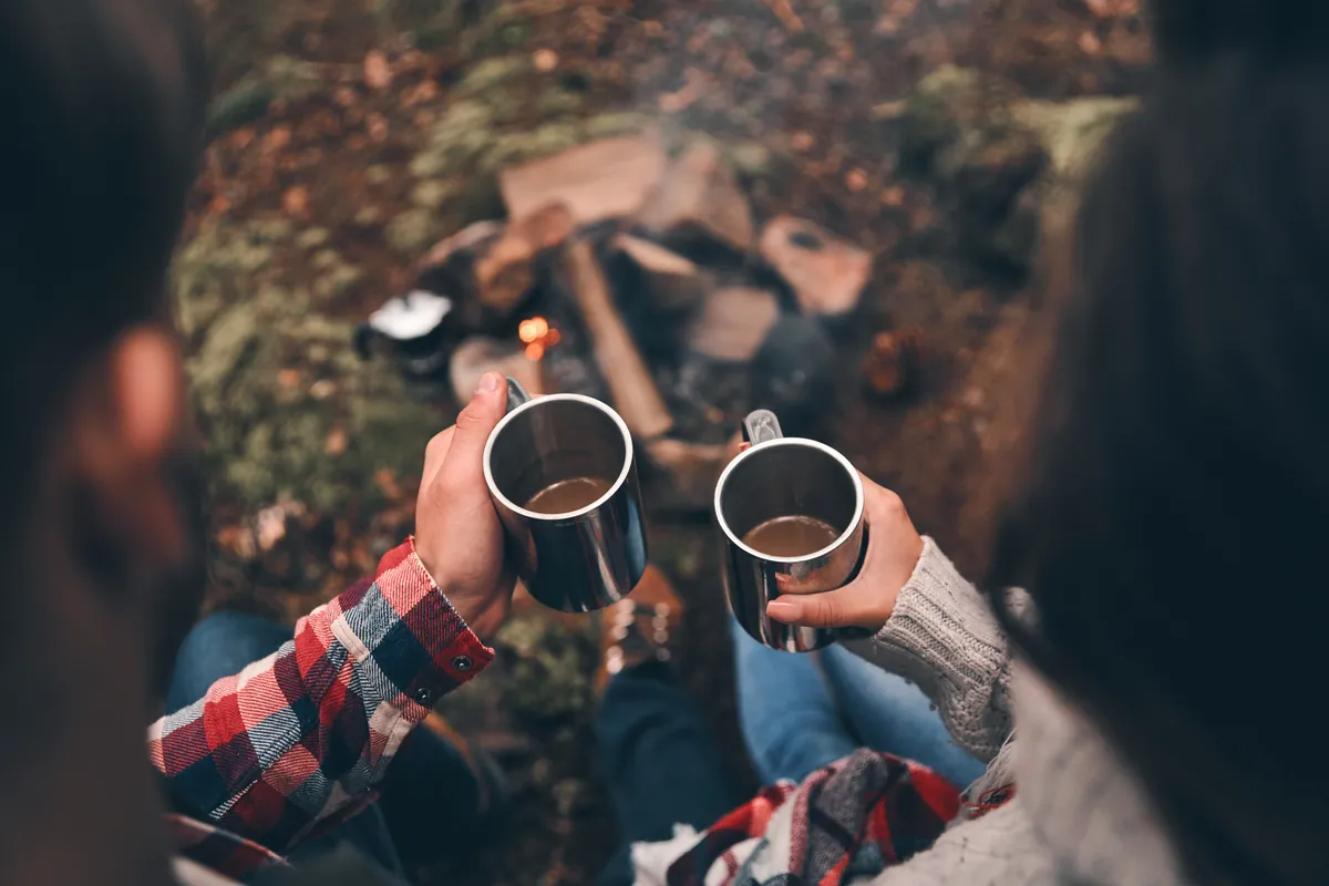 Metal coffee mugs by the campfire