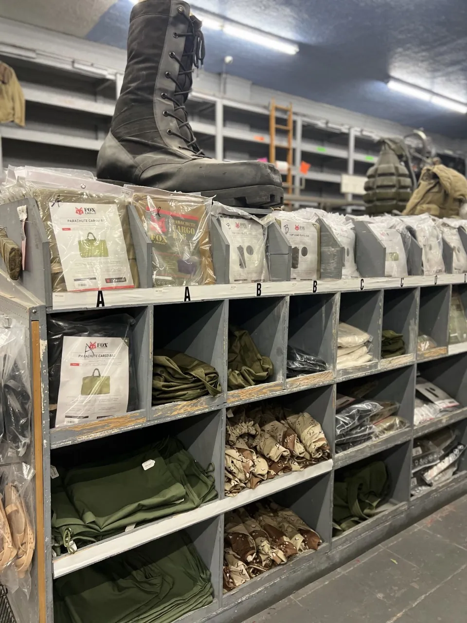 Shelves of military boots and surplus gear