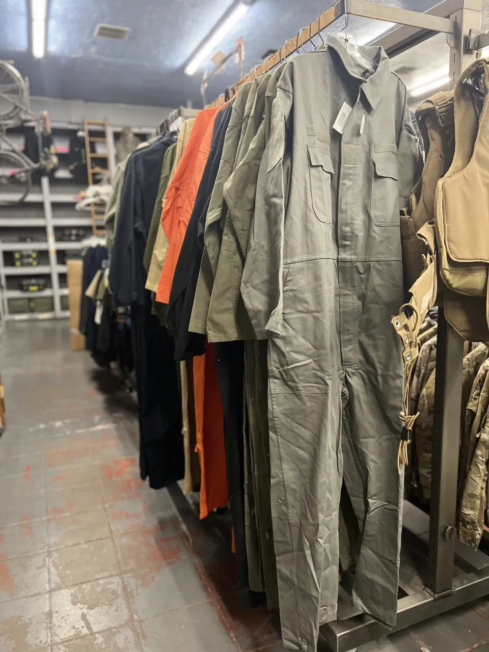Military uniforms and flight coveralls on the rack